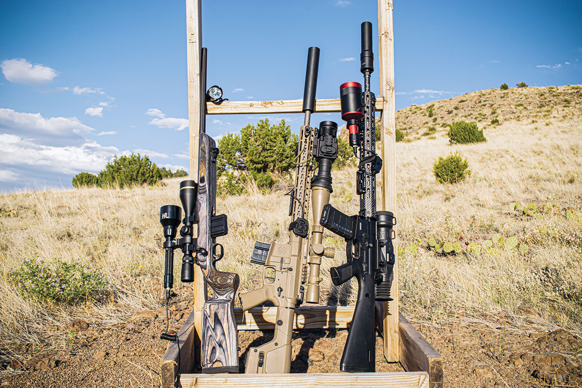 Three different setups are shown from left to right. They include a budget rig outfitted with a red light mounted to the optic; a deluxe setup with thermal optics and Texas Silencer Company’s Hunter silencer along with a mid-tier setup, using a Sightmark Wraith HD night-vision scope; and a Sniper Hog Lights Coyote Cannon IR illuminator.